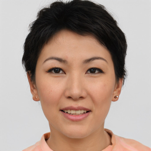 Joyful asian young-adult female with short  brown hair and brown eyes