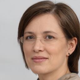 Joyful white adult female with medium  brown hair and brown eyes