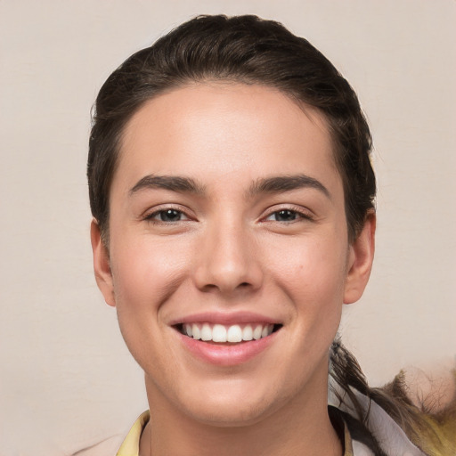 Joyful white young-adult male with medium  brown hair and brown eyes