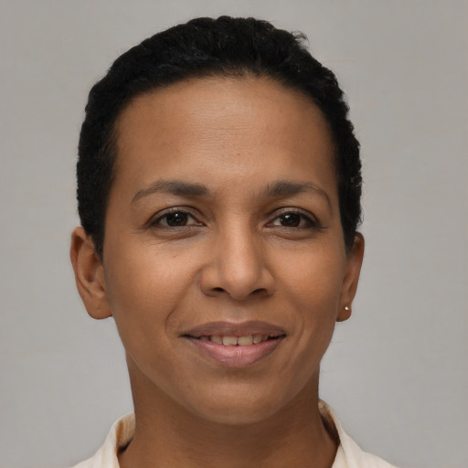 Joyful latino young-adult female with short  brown hair and brown eyes
