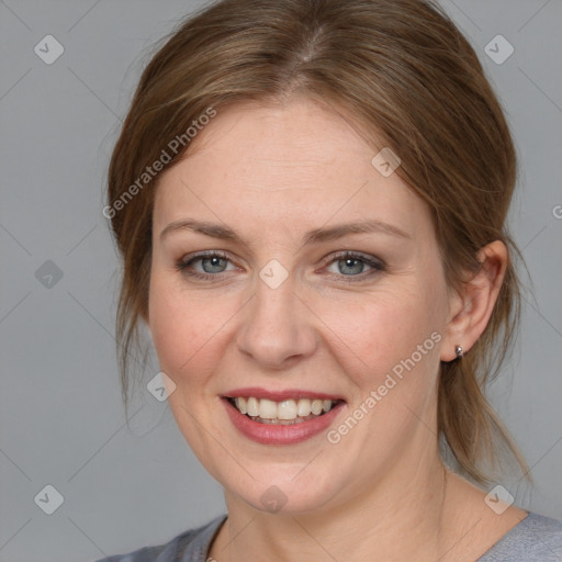 Joyful white young-adult female with medium  brown hair and blue eyes