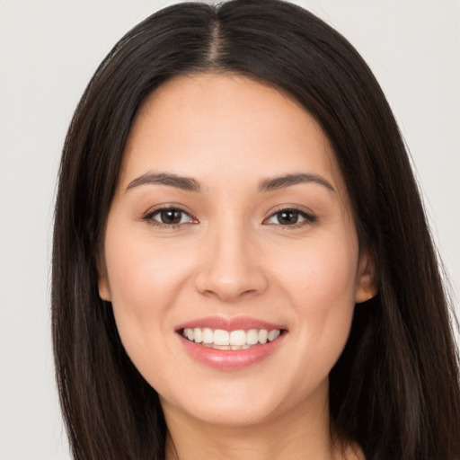 Joyful white young-adult female with long  brown hair and brown eyes