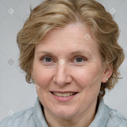 Joyful white adult female with medium  brown hair and blue eyes