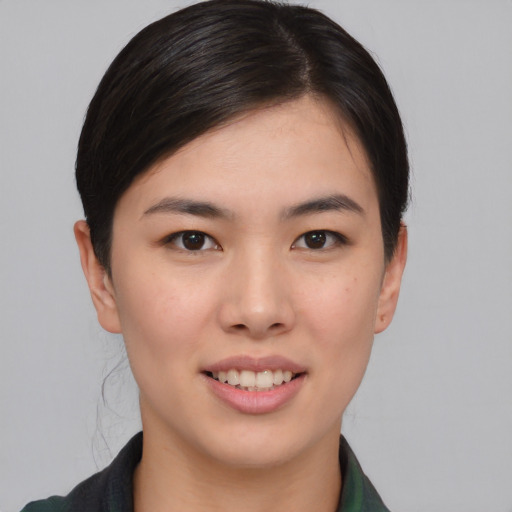 Joyful asian young-adult female with short  brown hair and brown eyes