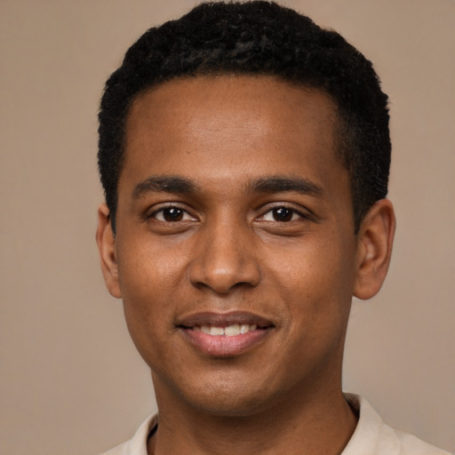 Joyful black young-adult male with short  brown hair and brown eyes