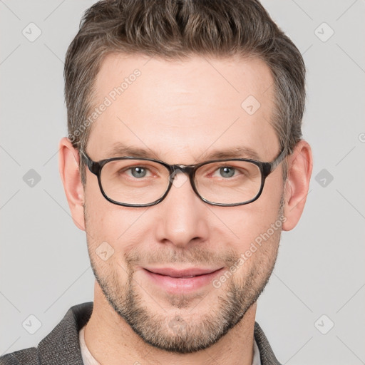 Joyful white adult male with short  brown hair and grey eyes