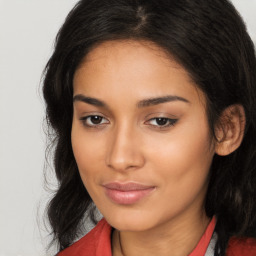 Joyful latino young-adult female with long  brown hair and brown eyes