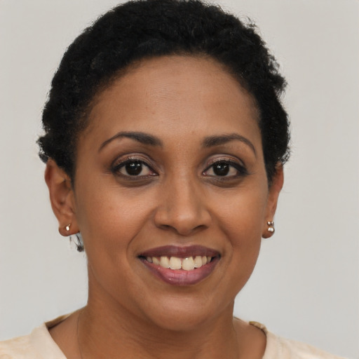Joyful latino adult female with short  brown hair and brown eyes