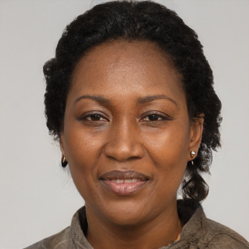 Joyful black adult female with short  black hair and brown eyes