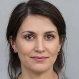 Joyful white adult female with medium  brown hair and brown eyes