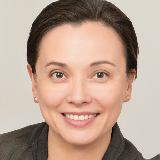 Joyful white adult female with short  brown hair and brown eyes