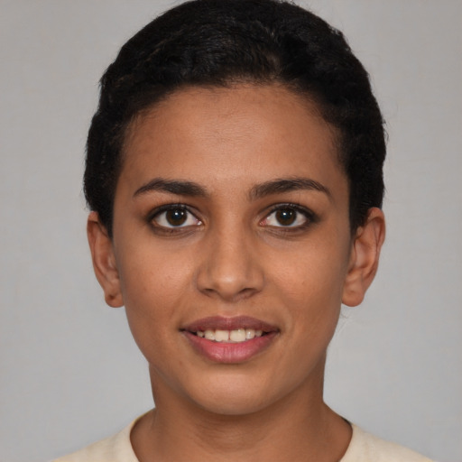 Joyful latino young-adult female with short  brown hair and brown eyes