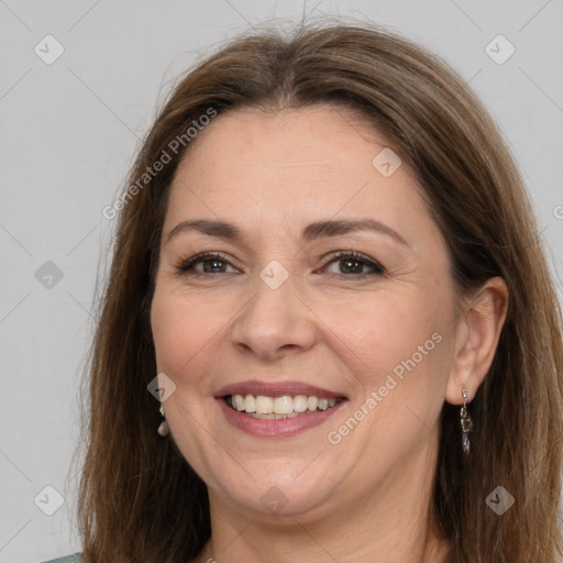 Joyful white adult female with long  brown hair and brown eyes