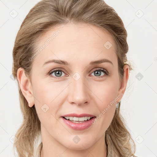 Joyful white young-adult female with long  brown hair and blue eyes