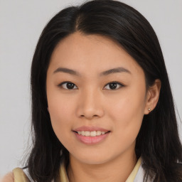 Joyful asian young-adult female with long  brown hair and brown eyes