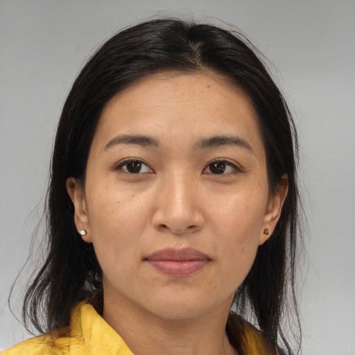 Joyful asian adult female with medium  brown hair and brown eyes