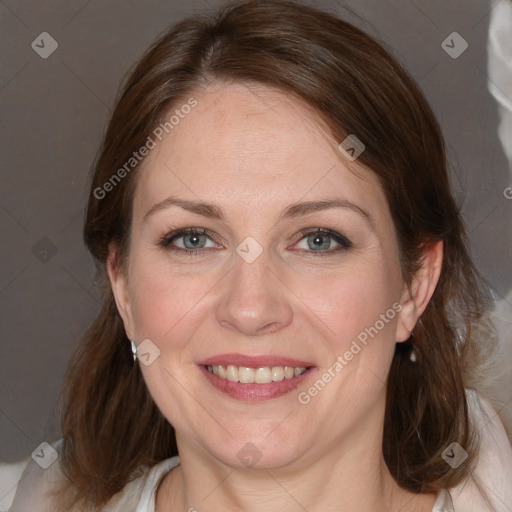 Joyful white adult female with medium  brown hair and blue eyes