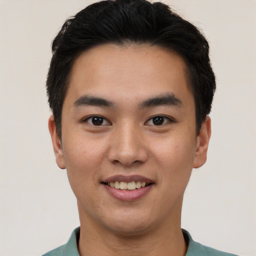 Joyful white young-adult male with short  black hair and brown eyes
