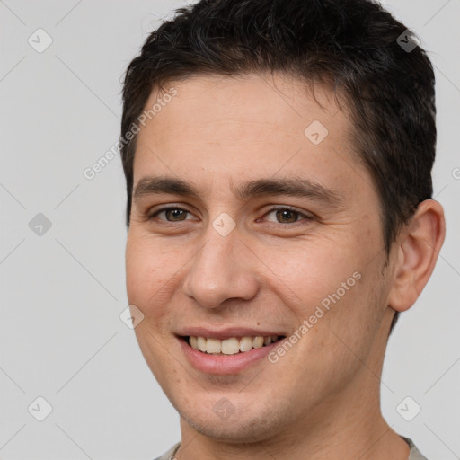 Joyful white young-adult male with short  brown hair and brown eyes