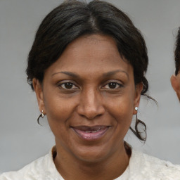 Joyful black adult female with short  brown hair and brown eyes