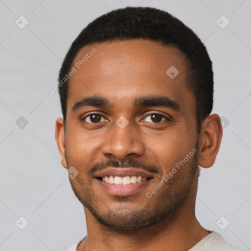 Joyful black young-adult male with short  black hair and brown eyes