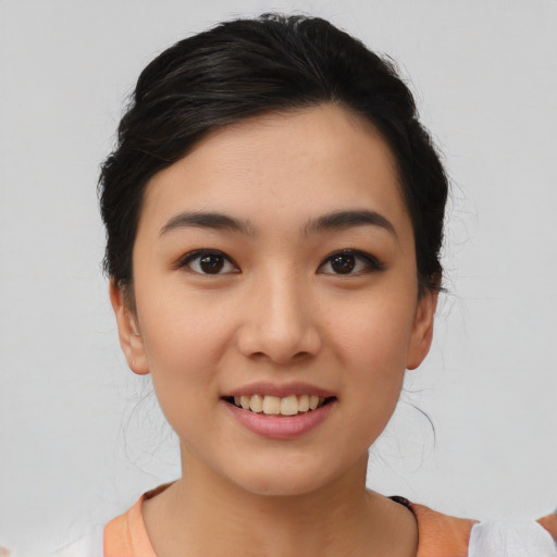 Joyful asian young-adult female with short  black hair and brown eyes