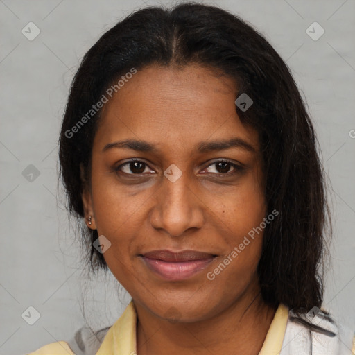 Joyful black adult female with medium  brown hair and brown eyes