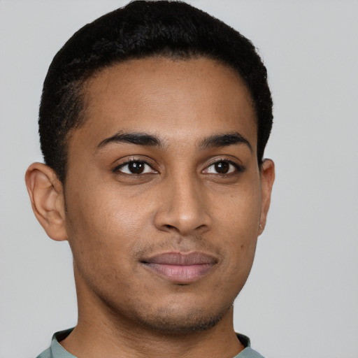 Joyful latino young-adult male with short  brown hair and brown eyes