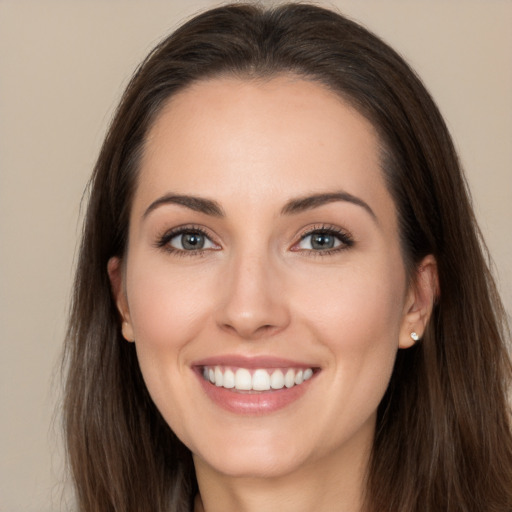 Joyful white young-adult female with long  brown hair and brown eyes