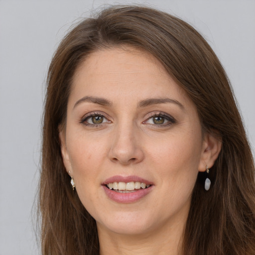 Joyful white young-adult female with long  brown hair and grey eyes