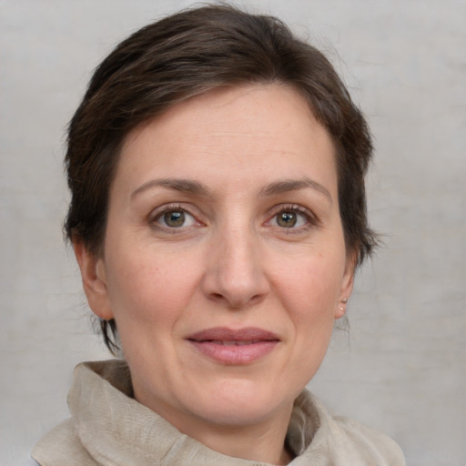 Joyful white adult female with medium  brown hair and grey eyes