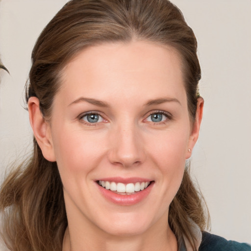 Joyful white young-adult female with medium  brown hair and grey eyes