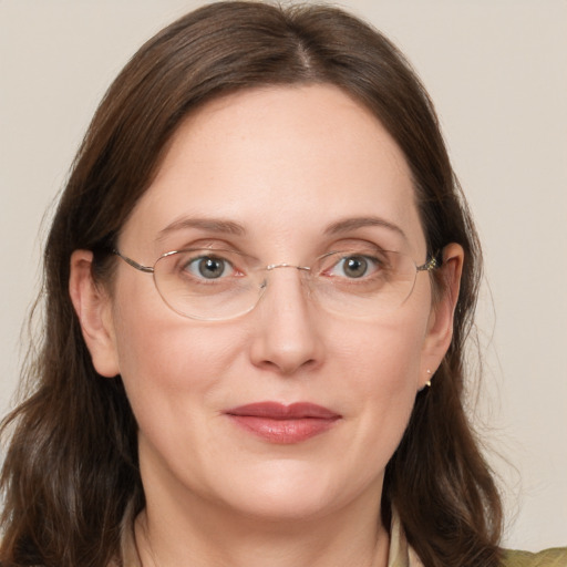 Joyful white adult female with medium  brown hair and grey eyes