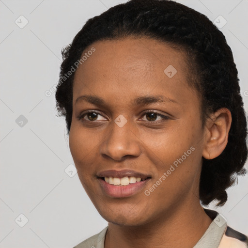 Joyful black young-adult female with short  black hair and brown eyes