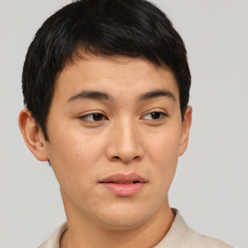 Joyful asian young-adult male with short  brown hair and brown eyes
