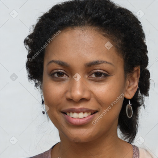 Joyful black young-adult female with long  brown hair and brown eyes