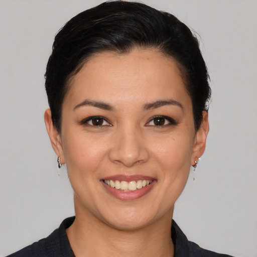 Joyful white young-adult female with short  black hair and brown eyes