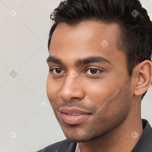 Joyful white young-adult male with short  black hair and brown eyes