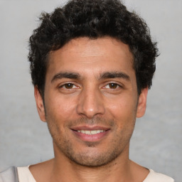 Joyful white young-adult male with short  black hair and brown eyes