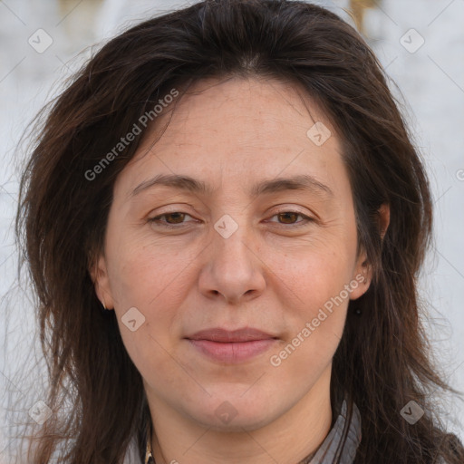 Joyful white adult female with long  brown hair and brown eyes