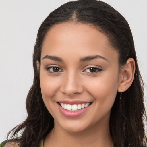 Joyful white young-adult female with long  brown hair and brown eyes