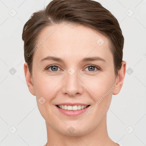 Joyful white young-adult female with short  brown hair and grey eyes