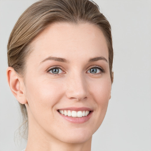 Joyful white young-adult female with short  brown hair and grey eyes