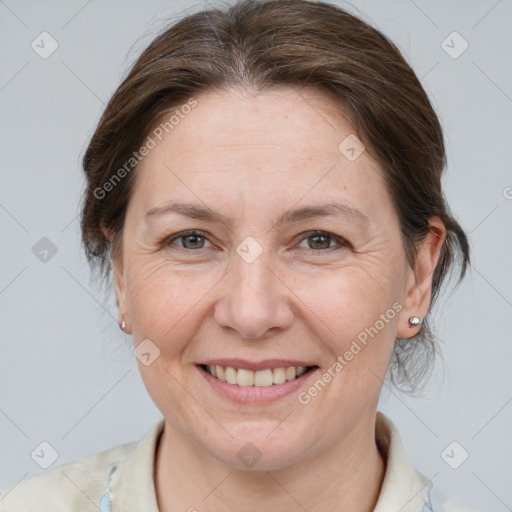 Joyful white adult female with medium  brown hair and grey eyes