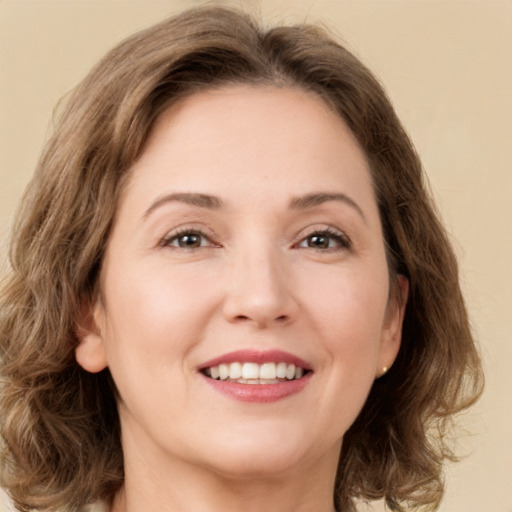 Joyful white young-adult female with medium  brown hair and green eyes