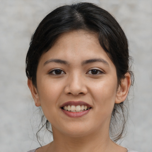 Joyful asian young-adult female with medium  brown hair and brown eyes