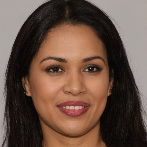 Joyful latino young-adult female with long  brown hair and brown eyes