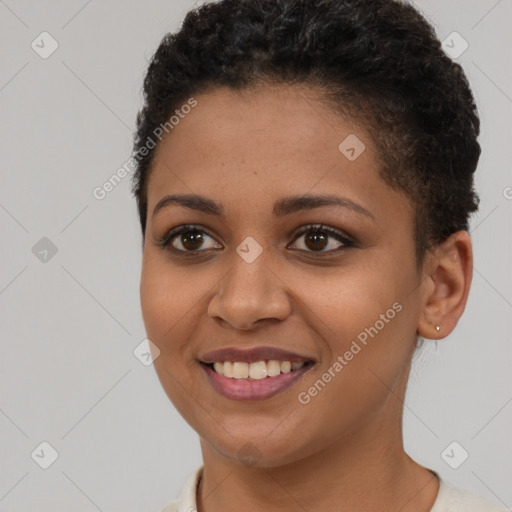 Joyful black young-adult female with short  brown hair and brown eyes