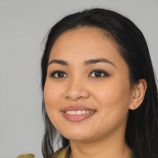 Joyful asian young-adult female with long  black hair and brown eyes
