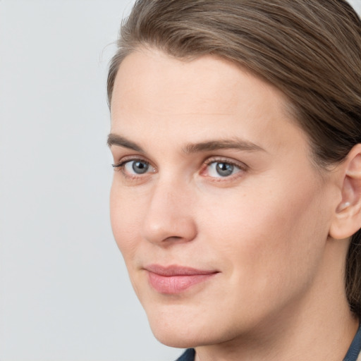 Joyful white young-adult female with medium  brown hair and blue eyes